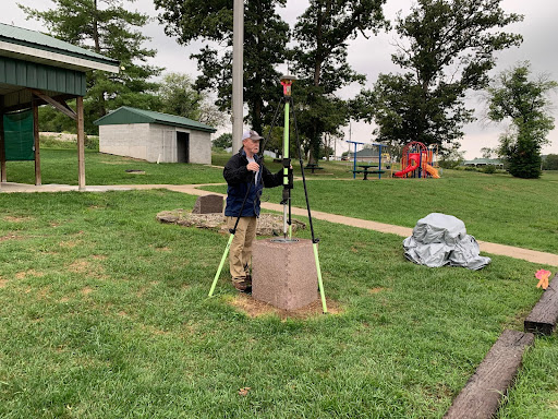 Credit: NOAA - NGS Central Plains Regional Geodetic Advisor, Brian Ward, conducts a GPS observation on the commemorative survey mark in Hartville City Park.